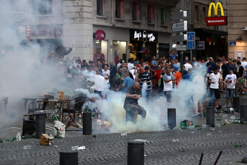MARSEILLE, FRANCE - JUNE 10:  A tear gas canister explodes under a football fan as England fans clash with police in Marseille on June 10, 2016 in Marseille, France. Football fans from around Europe have descended on France for the UEFA Euro 2016 football tournament.  (Photo by Carl Court/Getty Images)