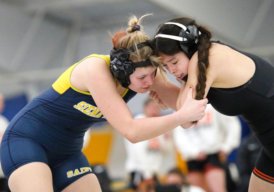 Maggie Mann of Siena Heights (left) and Indiana Tech's Brooklyn Figueroa battle Thursday night.