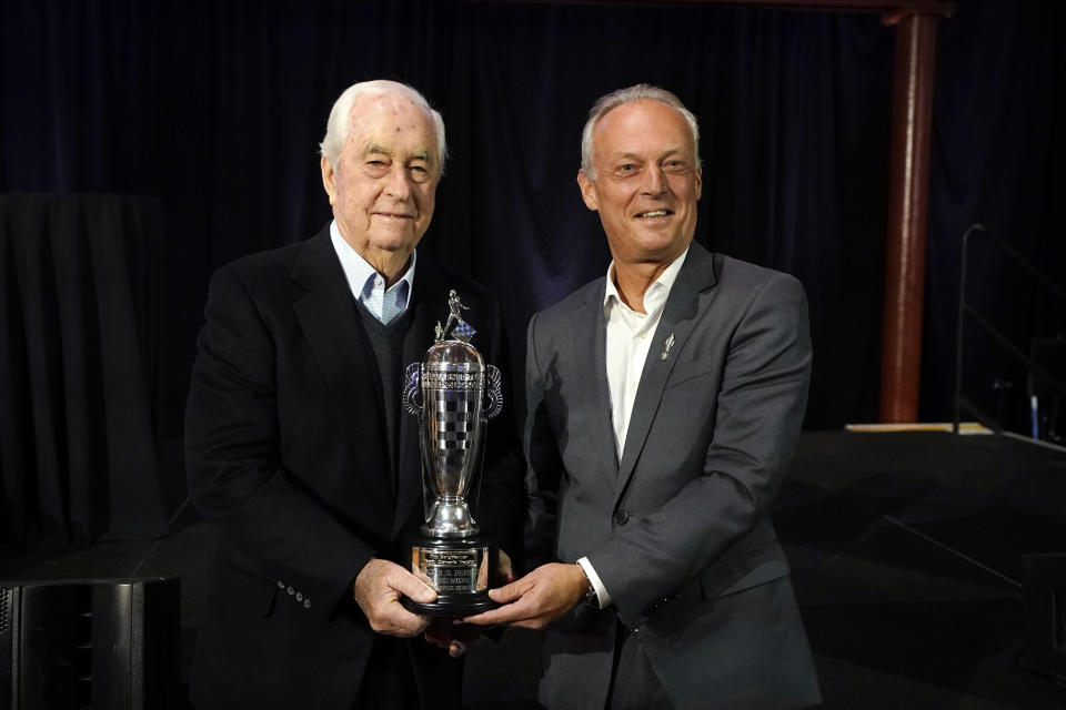 Fred Lissalde, right, president and CEO of BorgWarner stands next to team owner Roger Penske with a 2023 Indianapolis 500 Baby Borg trophiy, Tuesday, Jan. 23, 2024 in Dearborn, Mich. (AP Photo/Carlos Osorio)