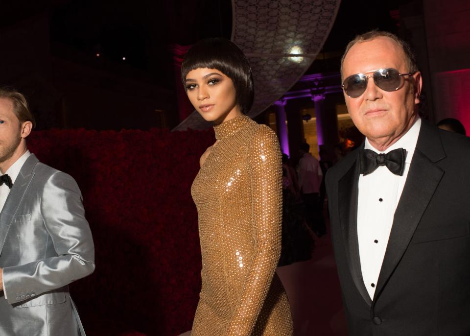 Zendaya wearing Michael Kors and walking with the designer at the 2016 Met gala.