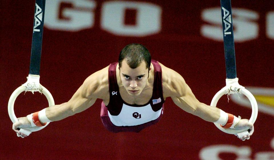 David Henderson works the still rings when he competed for OU during a meet against Air Force at Lloyd Noble Center in Norman in 2004.