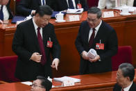 Chinese President Xi Jinping, left, chats with Chinese Premier Li Qiang after the opening session of the National People's Congress (NPC) at the Great Hall of the People in Beijing, China, Tuesday, March 5, 2024. (AP Photo/Andy Wong)