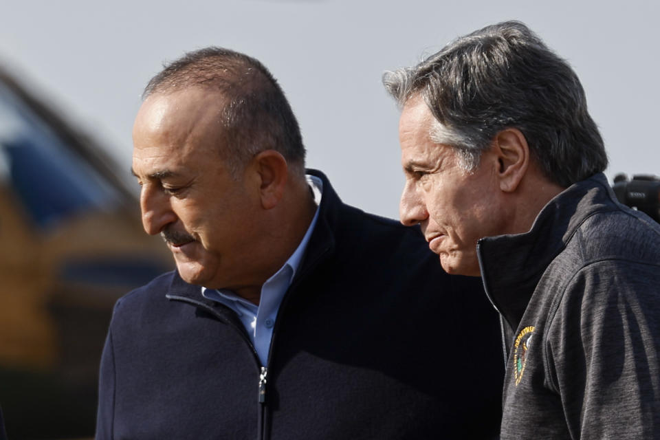 U.S. Secretary of State Antony Blinken is greeted by Turkish Foreign Minister Mevlut Cavusoglu, at Incirlik Air Base near Adana, Turkey, Sunday, Feb. 19, 2023. (Clodagh Kilcoyne/Pool Photo via AP)