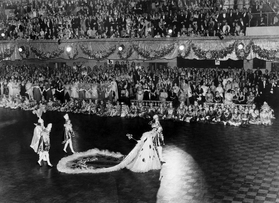 The King and Queen, in regal splendor, are seen at the Mardi Gras carnival's ball grand march Feb. 8, 1941. Her majesty, usually a debutante, wears an outfit that weighs up to 60lbs., with thousands of rhinestones that costs between $300 to $5,000 dollars. (AP Photo, file)