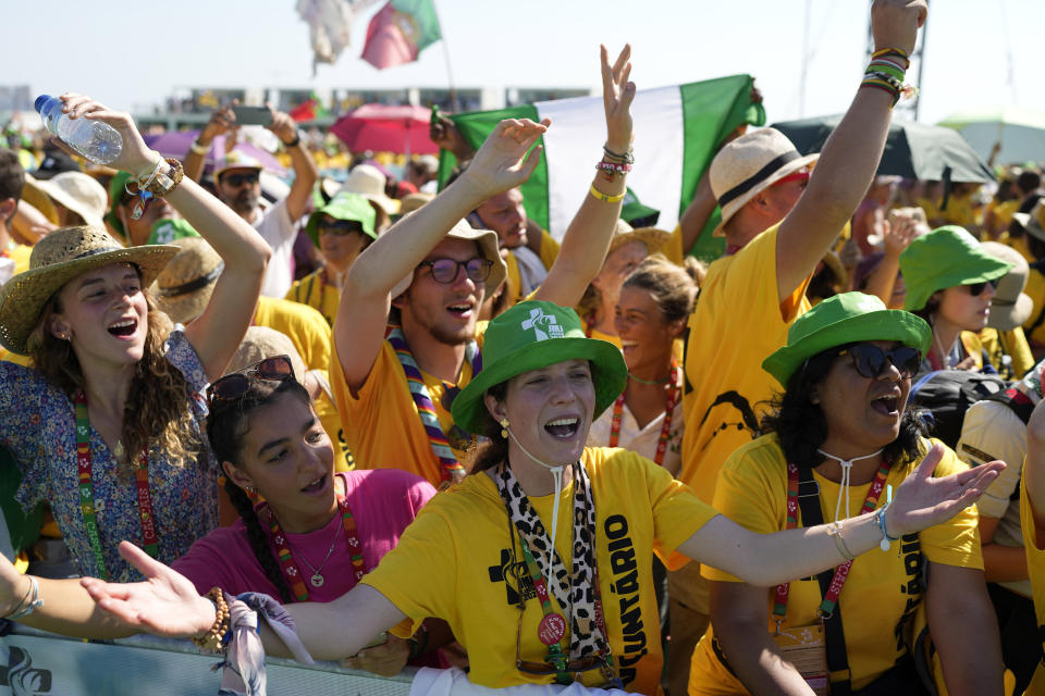 World Youth Day volunteers react as the Pope Francis arrives at Passeio Marítimo in Algés, just outside Lisbon, Sunday, Aug. 6, 2023. Pope Francis told young people on Sunday the Catholic Church needs them and urged them to follow their dreams as he wrapped up World Youth Day in Portugal with a massive open-air Mass and an announcement that the next edition would be held in Asia for the first time in three decades. (AP Photo/Armando Franca)