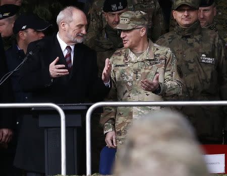 Polish Defence Minister Antoni Macierewicz (L) speaks to Commander of U.S. Forces in Europe, General Curtis Scaparrotti during U.S.-led NATO troops welcoming ceremony at polygon near Orzysz, Poland, April 13, 2017. REUTERS/Kacper Pempel