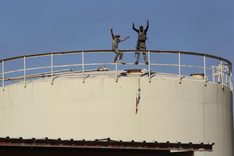 Iraqi government forces remove a Kurdish flag from the Bai Hassan oil field west of Kirkuk after seizing the installation from Kurdish forces on October 17, 2017 in a blow to Kurdish hopes for independence