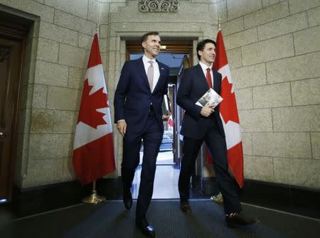 FILE PHOTO: Canada's Prime Minister Justin Trudeau and Finance Minister Bill Morneau walk from Trudeau's office to the House of Commons to deliver the budget on Parliament Hill in Ottawa, Ontario, Canada, March 22, 2017. REUTERS/Chris Wattie