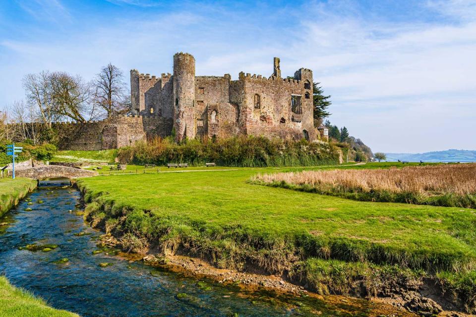 Ruins of the medieval castle at Laugharne by a stream of water