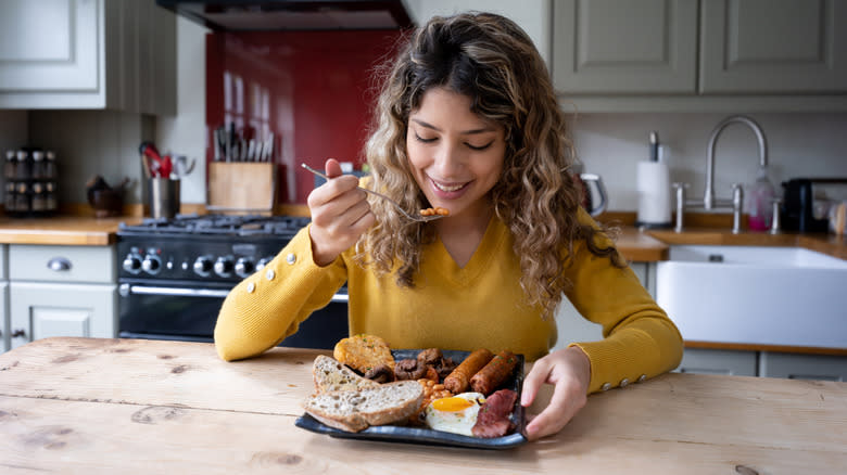 woman eating breakfast at table