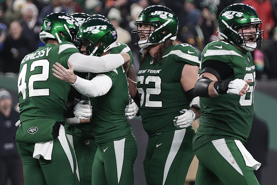 New York Jets place kicker Greg Zuerlein, second from left, celebrates with teammates after kicking a game-winning field goal against the Washington Commanders during the fourth quarter of an NFL football game, Sunday, Dec. 24, 2023, in East Rutherford, N.J. (AP Photo/Adam Hunger)