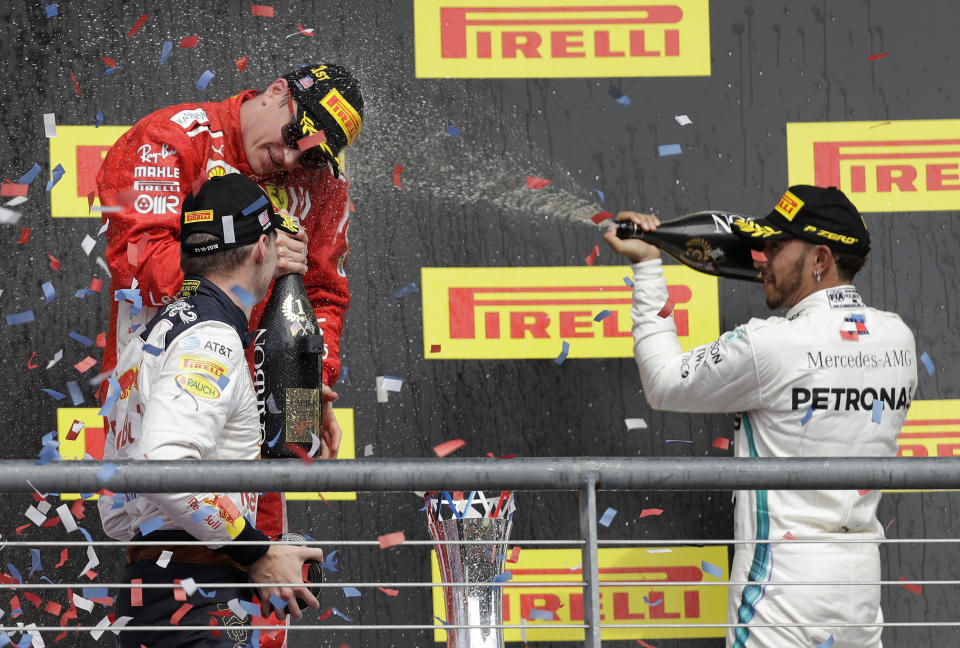 From left, Red Bull driver Max Verstappen, of the Netherlands, Ferrari driver Kimi Raikkonen, of Finland, and Mercedes driver Lewis Hamilton, of Britain, celebrate after the Formula One U.S. Grand Prix auto race at the Circuit of the Americas, Sunday, Oct. 21, 2018, in Austin, Texas. Raikkonen won the race. (AP Photo/Darron Cummings)