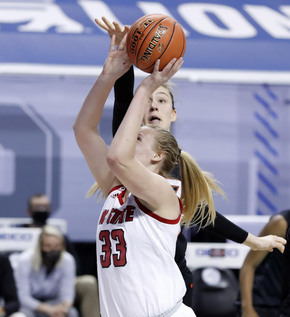 Virginia Tech's Elizabeth Kitley, rear, blocks the shot by North Carolina State's Elissa Cunane (33) during the first half of an NCAA college basketball game in the Atlantic Coast Conference women's tournament in Greensboro, N.C., Friday, March 5, 2021. (Ethan Hyman/The News & Observer via AP)