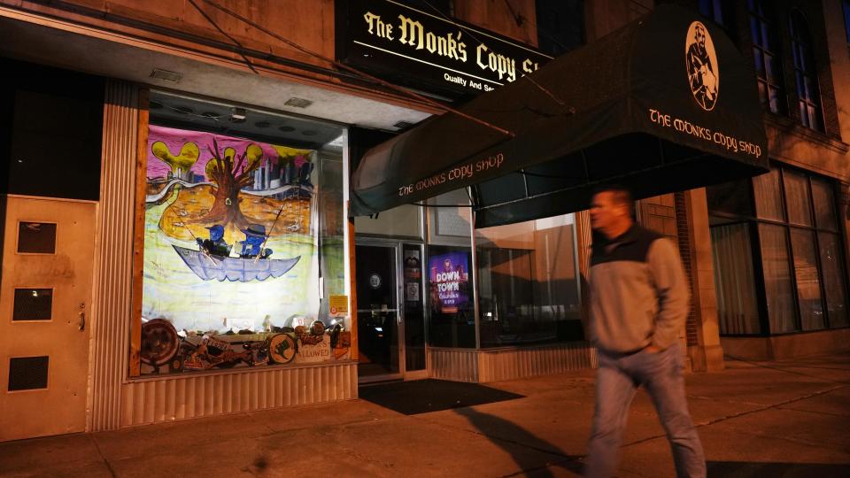 A man walks past Monk's Copy Shop, 47 E. Gay St., which features "3 Degrees Celsius," a window display by Dan Gerdeman and Rob W. Jones.