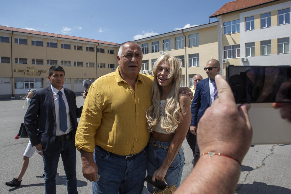 Bulgarian former prime minister Boyko Borissov takes a picture with a fan after voting in parliamentary elections in the town of Bankya near capital Sofia, Bulgaria on Sunday, July 11, 2021. Bulgarians are voting in a snap poll on Sunday after a previous election in April produced a fragmented parliament that failed to form a viable coalition government. Latest opinion polls suggest that the rerun could produce similar results but also a further drop in support for former Prime Minister Boyko Borissov's GERB party, after the current caretaker government made public allegations of widespread corruption during his rule. (AP PHOTO/Visar Kryeziu)