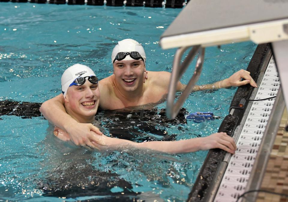 St. Xavier's Thackston McMullan and Jaeger Ellerman celebrate their 1-2 finish in the boys 100-yard freestyle at the Feb. 24, 2024, Ohio High School Athletic Association Division I state swimming and diving meet in Canton, Ohio.