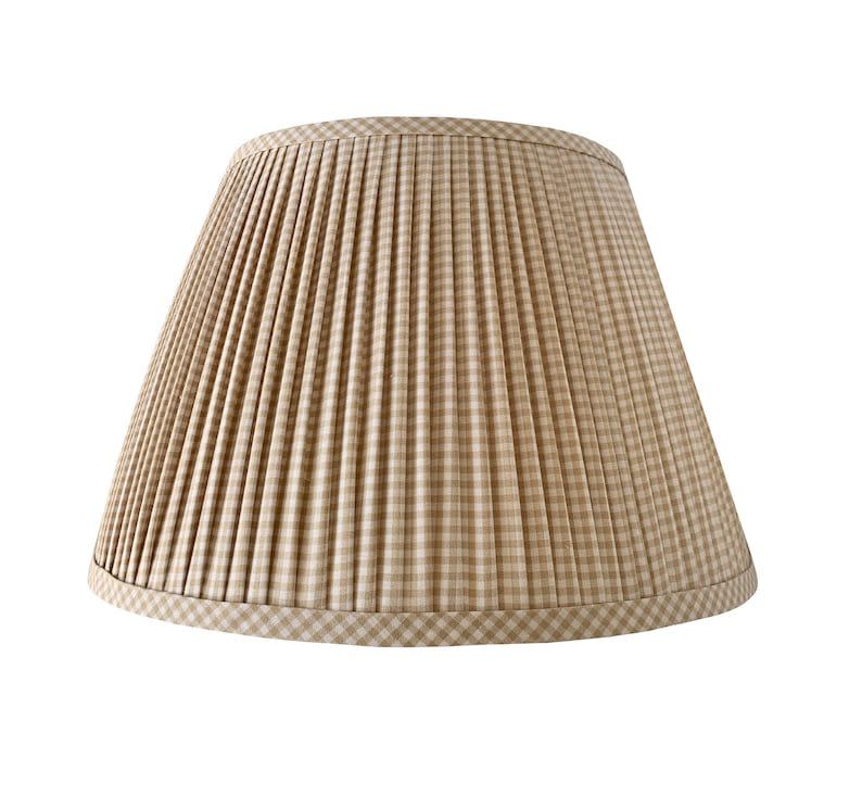 <p><a href="https://go.redirectingat.com?id=74968X1596630&url=https%3A%2F%2Fwww.etsy.com%2Flisting%2F869862267%2Fpleated-lampshade-beige-lamp-shade-blue&sref=https%3A%2F%2F" rel="nofollow noopener" target="_blank" data-ylk="slk:Shop Now;elm:context_link;itc:0;sec:content-canvas" class="link ">Shop Now</a></p><p>Pleated Gingham Lampshade</p><p>etsy.com</p><p>$110.17</p>