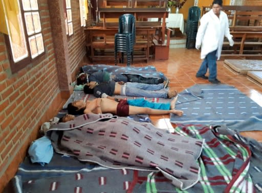 A medic looks at the bodies of five people killed during clashes between Bolivian security forces and supporters of ex-president Evo Morales in Sacaba, Chapare province, Cochabamba department on November 15, 2019