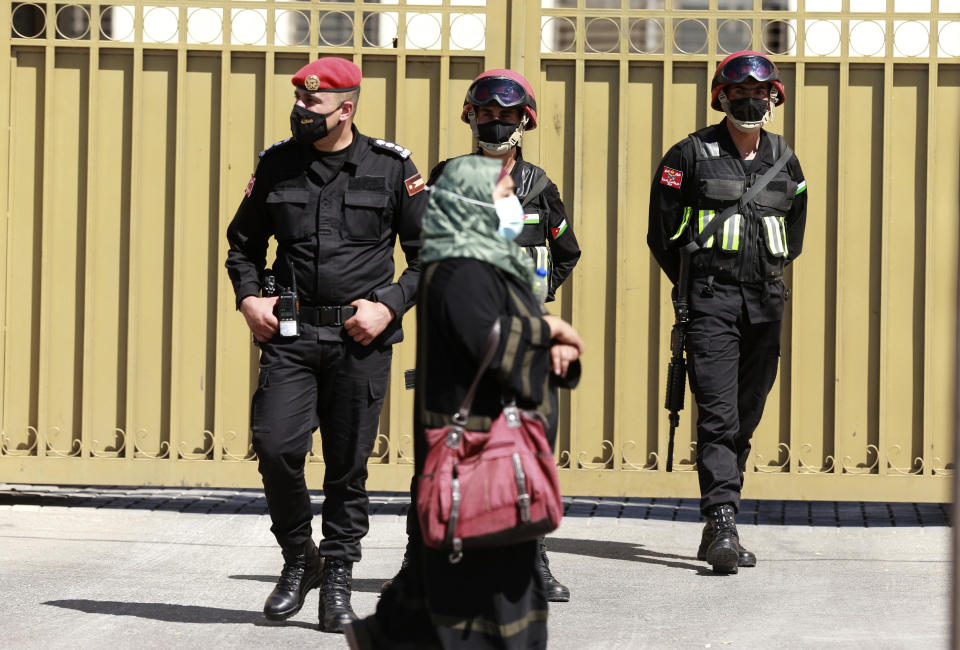 Security forces stand outside the state security court where the trial of Bassem Awadallah, a former royal adviser, and Sharif Hassan bin Zaid, a distant cousin of the king, is taking place, in Amman, Jordan, Monday, June. 21, 2021. Awadallah, who has Jordanian, U.S. and Saudi citizenship, and bin Zaid, pleaded not guilty Monday to sedition and incitement charges, a defense lawyer said. The defendants are accused of conspiring with a senior royal — Prince Hamzah, a half-brother of the king — to foment unrest against the monarch while soliciting foreign help. (AP Photo/Raad Adayleh)