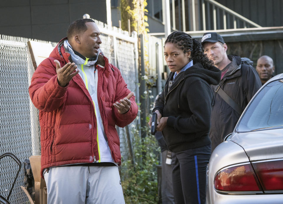 This image released by Sony Pictures shows director Deon Taylor, left, and Naomie Harris on the set of Screen Gems "Black and Blue." After making successful movies independently for 15 years, Hollywood is starting to take notice of Taylor. This year he has two major films in theaters. “The Intruder” became a solid hit in May, and his police thriller “Black and Blue” opens nationwide Thursday. (Alan Markfield/Sony Pictures via AP)