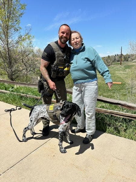 Officer Austin Speer and K-9 Mercuy take a picture with the missing woman they found in Greenwood Village, Colorado on Thursday, May 2, 2024.