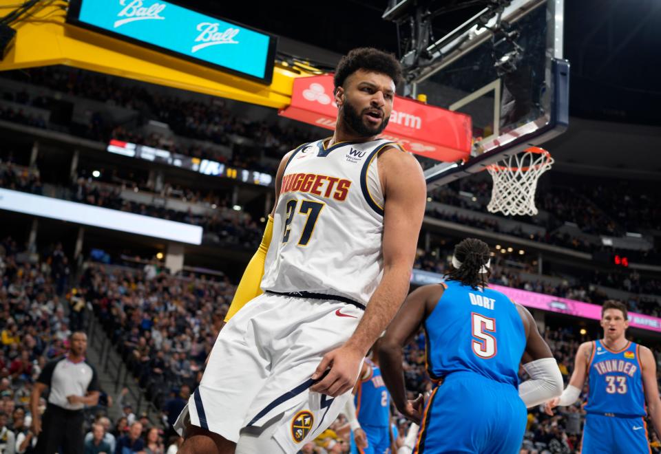 Denver Nuggets guard Jamal Murray reacts after scoring a bsket against the Oklahoma City Thunder in the first half of an NBA basketball game, Sunday, Jan. 22, 2023, in Denver. (AP Photo/David Zalubowski)