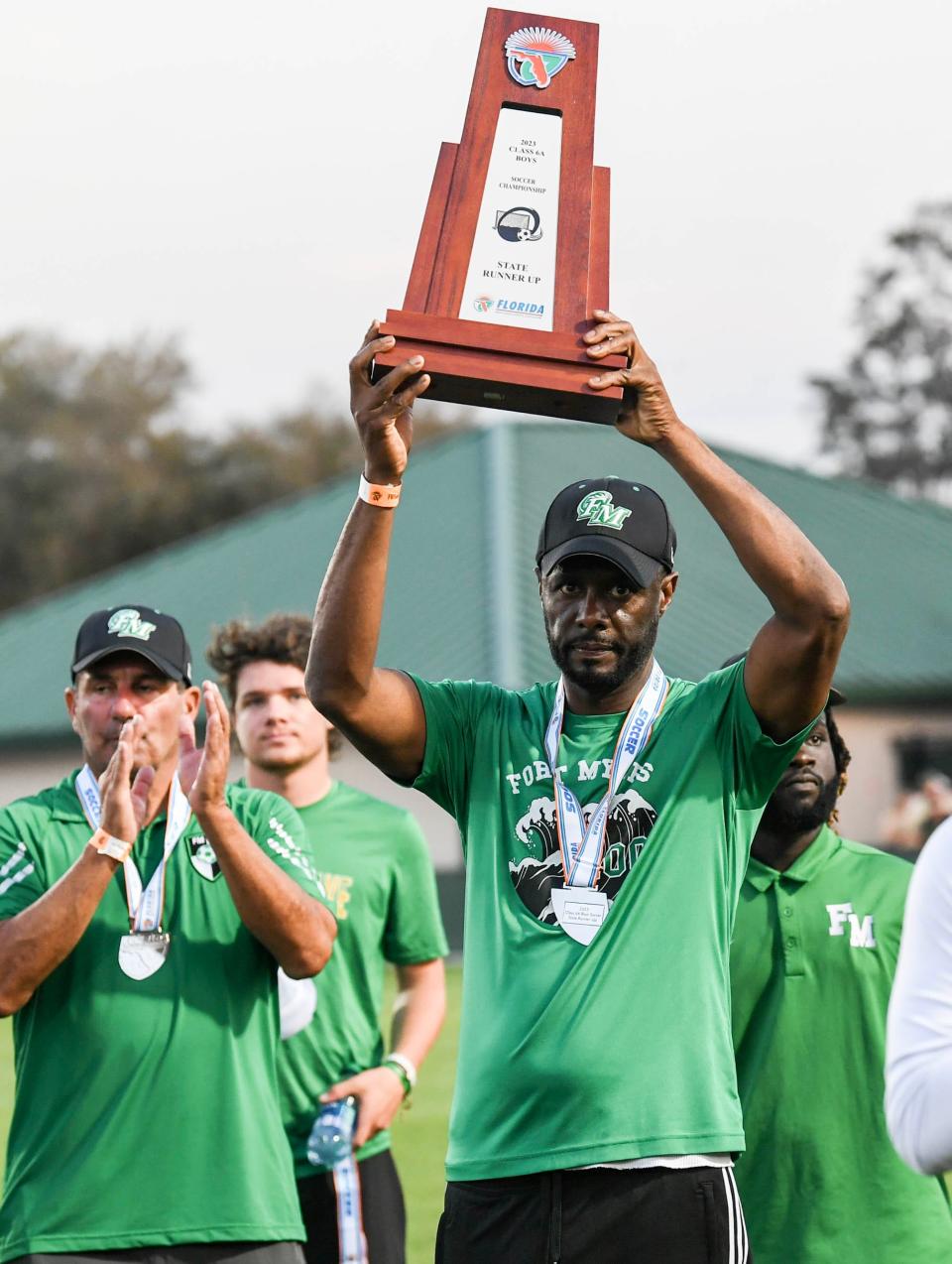 Fort Myers head coach Chris Reid holds up the runner up trophy after the Green Wave lost to Viera 4-2 in the FHSAA state soccer championship Saturday, February 25, 2023. Craig Bailey/FLORIDA TODAY via USA TODAY NETWORK