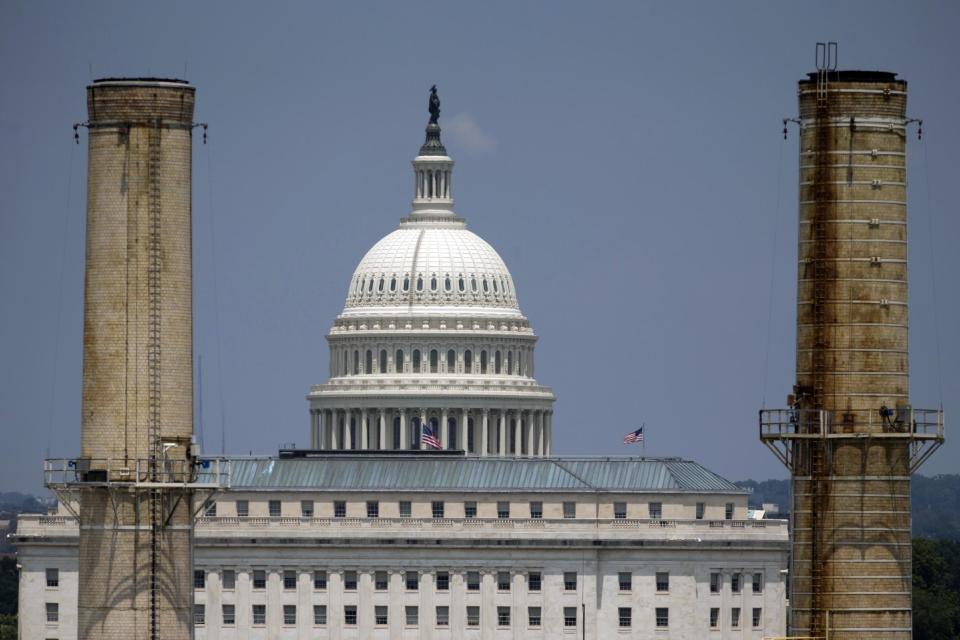 FILE - In this June 24, 2013, file photo, the Capitol Dome is seen behind the Capitol Power Plant in Washington. Democrats running for election in key states are worried about the political fallout from unprecedented greenhouse-gas limits soon to be announced by fellow Democrat Barack Obama's administration. They wish Obama would wait until after November's elections, but if he doesn't start now the rules won't be in place by the time he leaves office. (AP Photo/Carolyn Kaster, File)