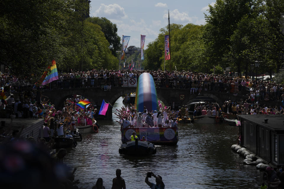 Hundreds of thousands of people lined canals in the Dutch capital to watch the colorful spectacle of the Pride Canal Parade return for the 25th edition after the last two events were canceled due to the COVID-19 pandemic, in Amsterdam, Netherlands, Saturday, Aug. 6, 2022. (AP Photo/Peter Dejong)