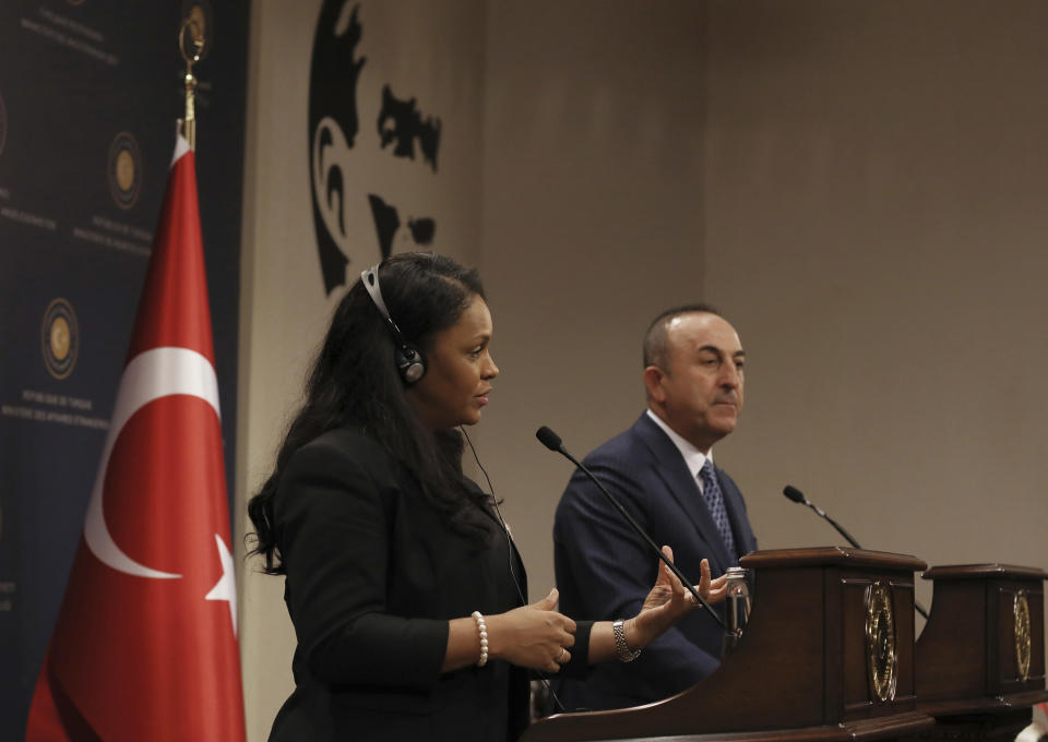 Turkey's Foreign Minister Mevlut Cavusoglu, right, and Guinea-Bissau Foreign Minister Suzi Carla Barbosa takes part in a joint news conference after their talks, in Ankara, Turkey, Monday, Oct. 28, 2019. (AP Photo/Burhan Ozbilici)