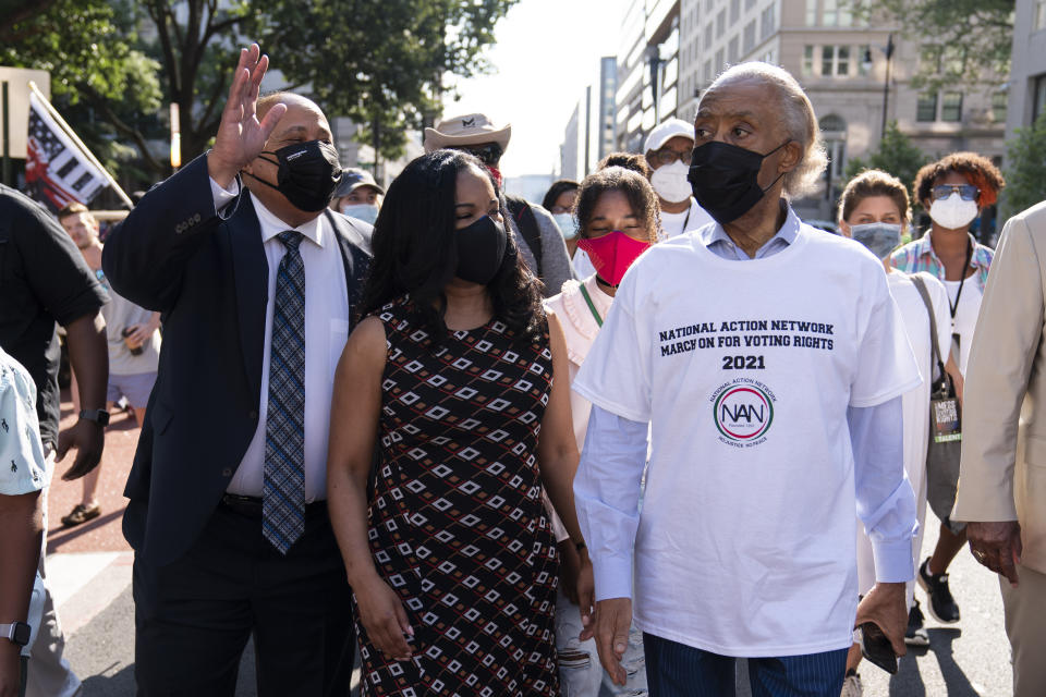 The Rev. Al Sharpton, right, with Martin Luther King, III, left, walk during a march for voting rights, marking the 58th anniversary of the March on Washington, Saturday, Aug. 28, 2021, in Washington. Hundreds of thousands of voting rights advocates rallied across the country Saturday to call for sweeping protections against a further erosion of the Voting Rights Act of 1965. (AP Photo/Jose Luis Magana)