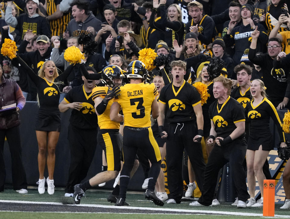 Iowa defensive back John Nestor, center left, celebrates after a touchdown by defensive back Cooper DeJean (3) who returned a punt during the second half of an NCAA college football game against Minnesota, Saturday, Oct. 21, 2023, in Iowa City, Iowa. DeJean's touchdown was called back upon official review. (AP Photo/Matthew Putney)