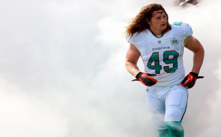 Dec 27, 2015; Miami Gardens, FL, USA; Miami Dolphins linebacker Zach Vigil (49) is introduced before a game against the Indianapolis Colts at Sun Life Stadium. The Colts won 18-12. Mandatory Credit: Steve Mitchell-USA TODAY Sports