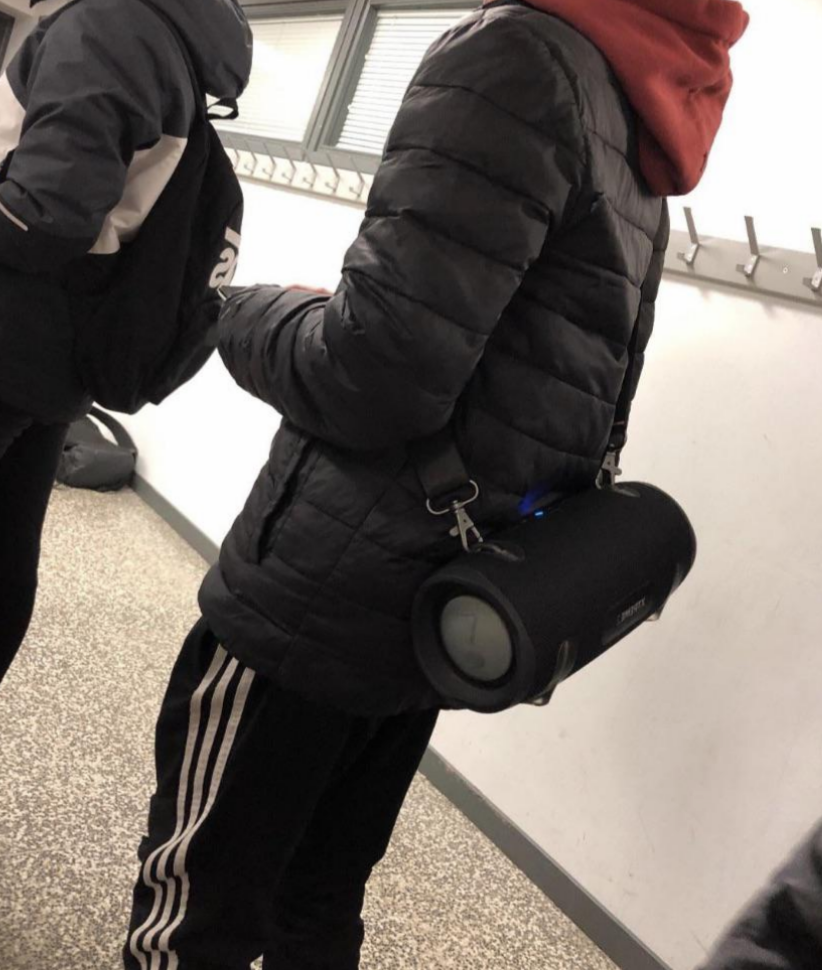 A person with a portable speaker on their back
