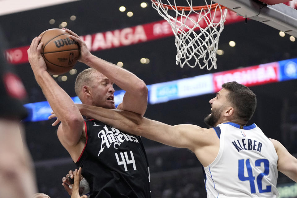 Los Angeles Clippers center Mason Plumlee, left, tries to shoot as Dallas Mavericks forward Maxi Kleber reaches in during the first half in Game 2 of an NBA basketball first-round playoff series Tuesday, April 23, 2024, in Los Angeles. (AP Photo/Mark J. Terrill)