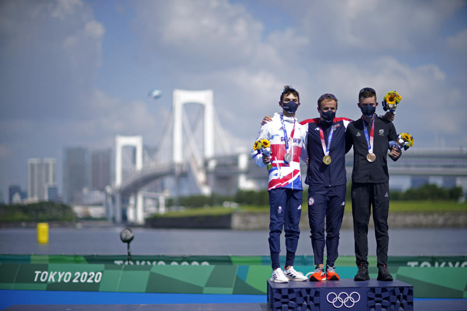 Gold medal winner Kristian Blummenfelt of Norway, center, poses with silver medalist Alex Yee of Great Britain, left, and bronze medalist Hayden Wilde of New Zealand during a medal ceremony for the men's individual triathlon at the 2020 Summer Olympics, Monday, July 26, 2021, in Tokyo, Japan. (AP Photo/David Goldman)