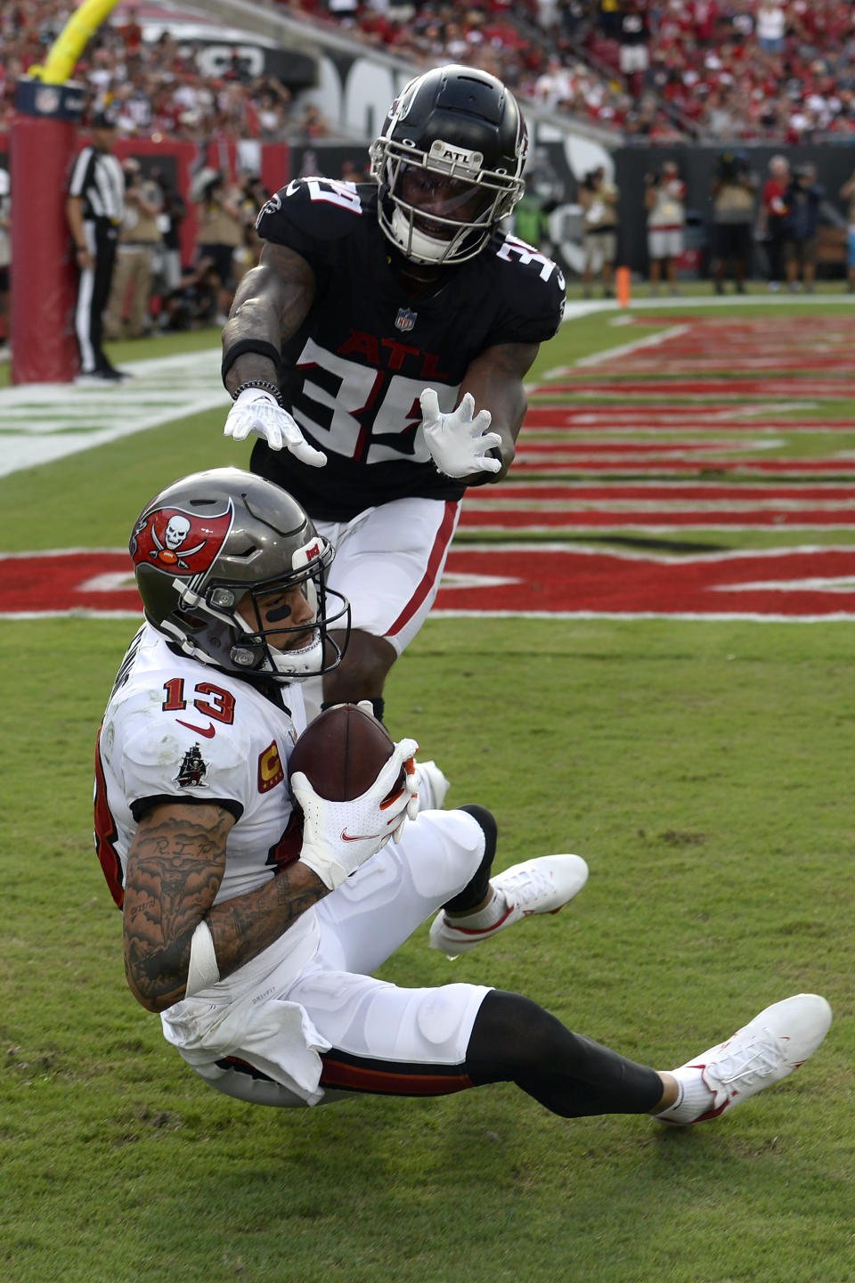 **CORRECTS ATLANTA DEFENDER TO T.J. GREEN**Tampa Bay Buccaneers wide receiver Mike Evans (13) beats Atlanta Falcons defensive back T.J. Green (39) on a 1-yard touchdown reception during the second half of an NFL football game Sunday, Sept. 19, 2021, in Tampa, Fla. (AP Photo/Jason Behnken)