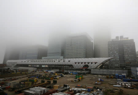 FILE PHOTO: A low fog engulfs the skyscrapers of the financial district of Canary Wharf in London, Britain April 9, 2018. REUTERS/Kevin Coombs/File Photo