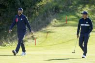 Team USA's Dustin Johnson and Team USA's Collin Morikawa walk to the ninth green during a foursomes match the Ryder Cup at the Whistling Straits Golf Course Saturday, Sept. 25, 2021, in Sheboygan, Wis. (AP Photo/Charlie Neibergall)