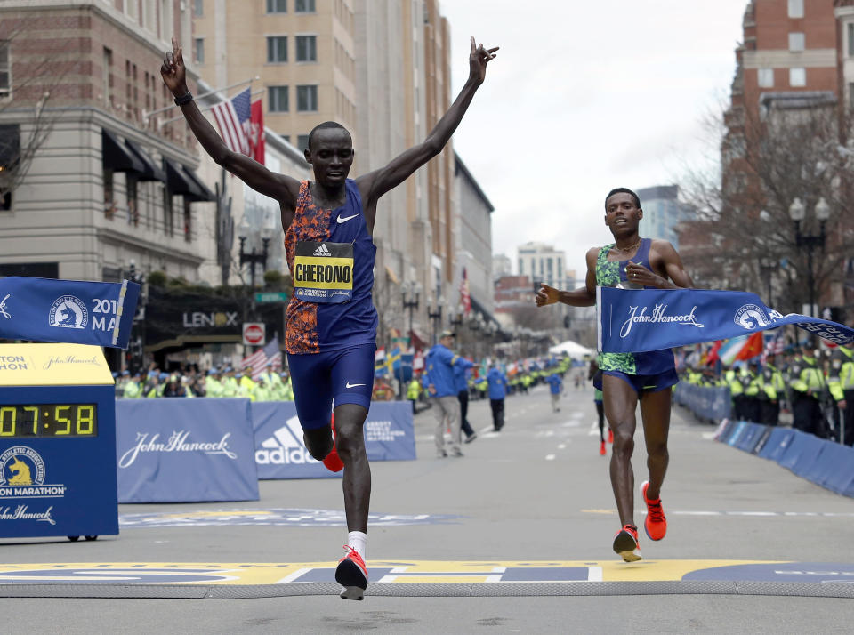 Lawrence Cherono, of Kenya, breaks the tape to win the 123rd Boston Marathon in front of Lelisa Desisa, of Ethiopia, right, on Monday, April 15, 2019, in Boston. (AP Photo/Winslow Townson)