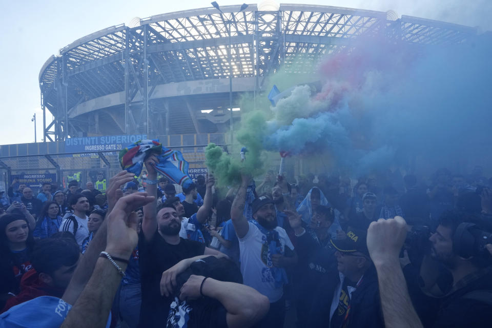 Napoli fans cheer in front of the Diego Armando Maradona stadium, in Naples, Italy, Thursday, May 4, 2023. (AP Photo/Andrew Medichini)