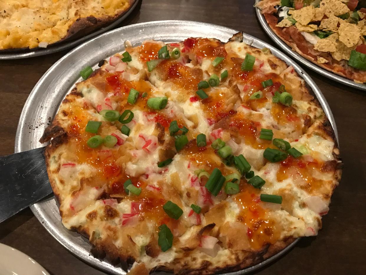 Crab rangoon pizza drizzled in sweet chili sauce from Pizza Garden in Manitowoc.