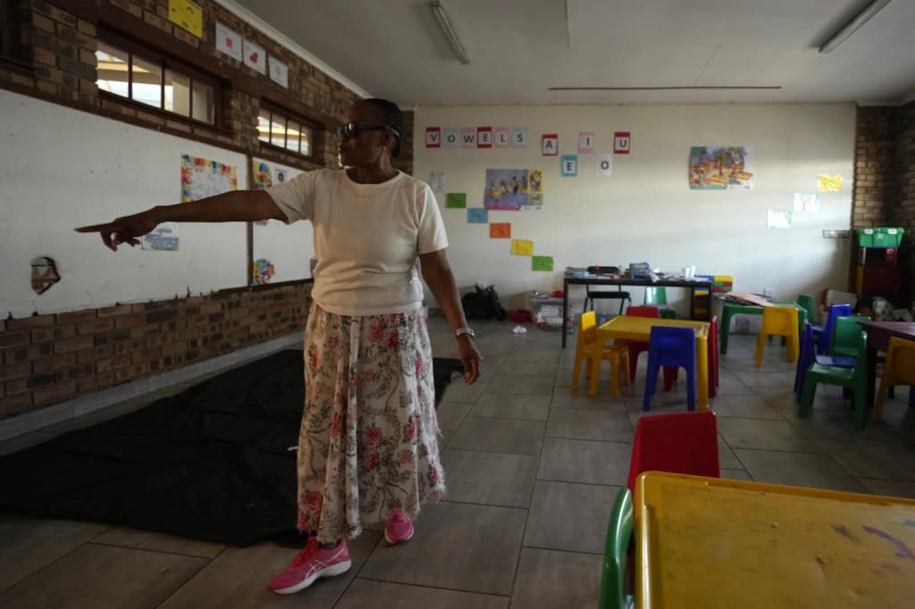 Lily Makhanya opens the classroom door at Thabisang Primary School where she voted for the first time 30 years ago, in Soweto, South Africa, Monday, April 22, 2024. (AP Photo/Themba Hadebe)