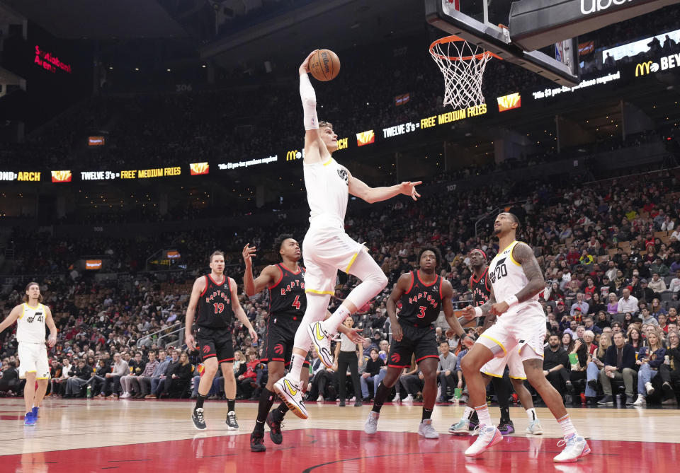 Utah Jazz forward Lauri Markkanen, center top, goes up to score against the Toronto Raptors during first-half NBA basketball game action in Toronto, Saturday, Dec. 23, 2023. (Chris Young/The Canadian Press via AP)