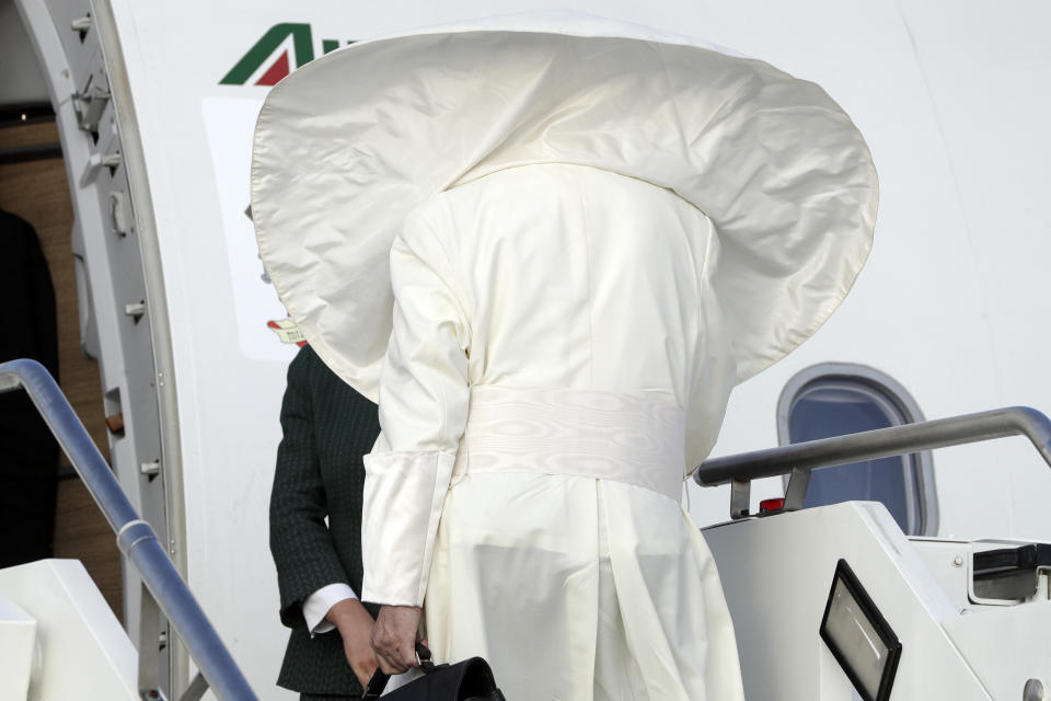 A gust of wind blows Pope Francis' cape as he boards an airplane at Rome's Fiumicino international airport, Saturday, Aug. 25, 2018. The pontiff is traveling to Ireland for a two-day visit on the occasion of the 2018 World Meeting of Families. (AP Photo/Andrew Medichini)