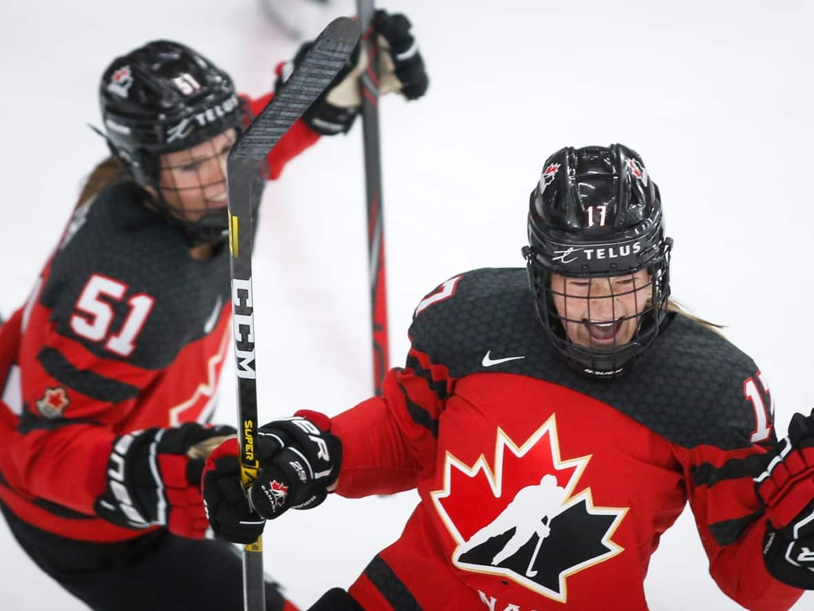 Canada's Ella Shelton, right, and Victoria Bach, left, seen above during the 2021 women's hockey world championships, will participate in multiple significant events in the sport over the next two months. (Jeff McIntosh/The Canadian Press - image credit)