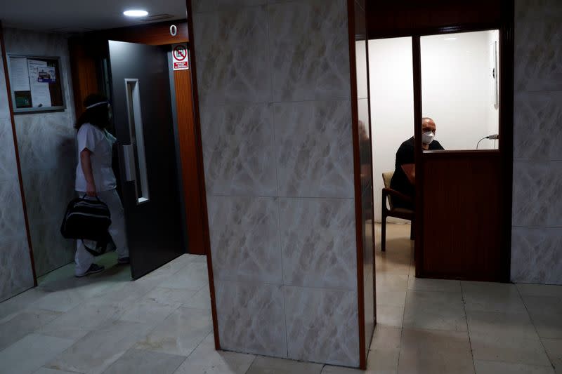 Comunidad de Madrid home care nurse Maria Jesus Santamaria arrives at an apartment complex to treat a COVID-19 patient in Madrid