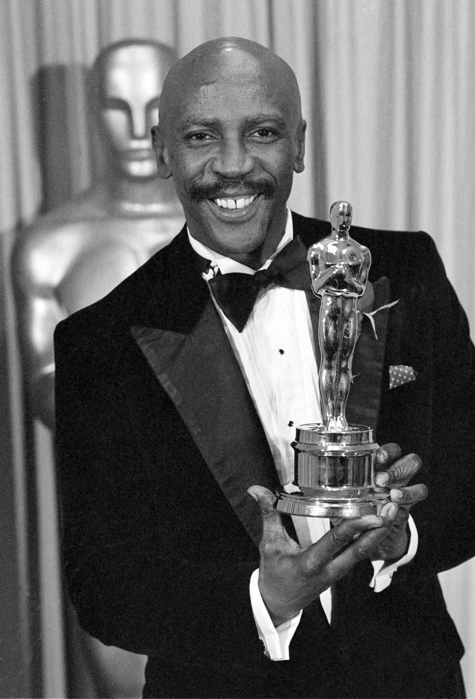 Louis Gossett Jr poses with the Oscar for best supporting actor for his role in An Officer and a Gentleman (AP)