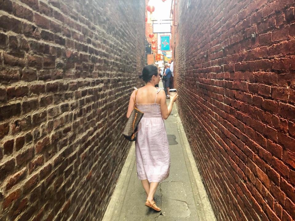 simone walking down fan tan alley in chinatown in victoria canada