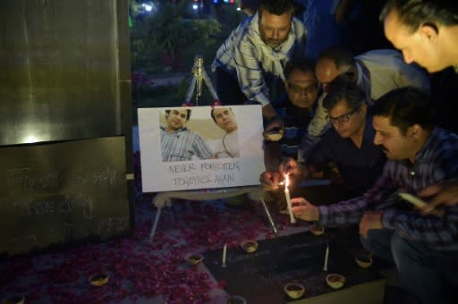 Journalists around the world have mourned the killing of AFP's Shah Marai, pictured here with Sardar Ahmad -- an AFP reporter who was killed in a 2014 attack alongside his wife and children